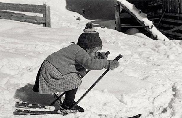 Bambina che scia sulla neve con abbigliamento invernale.