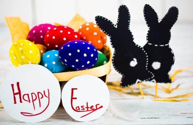 Basket of colorful Easter eggs with bunnies.